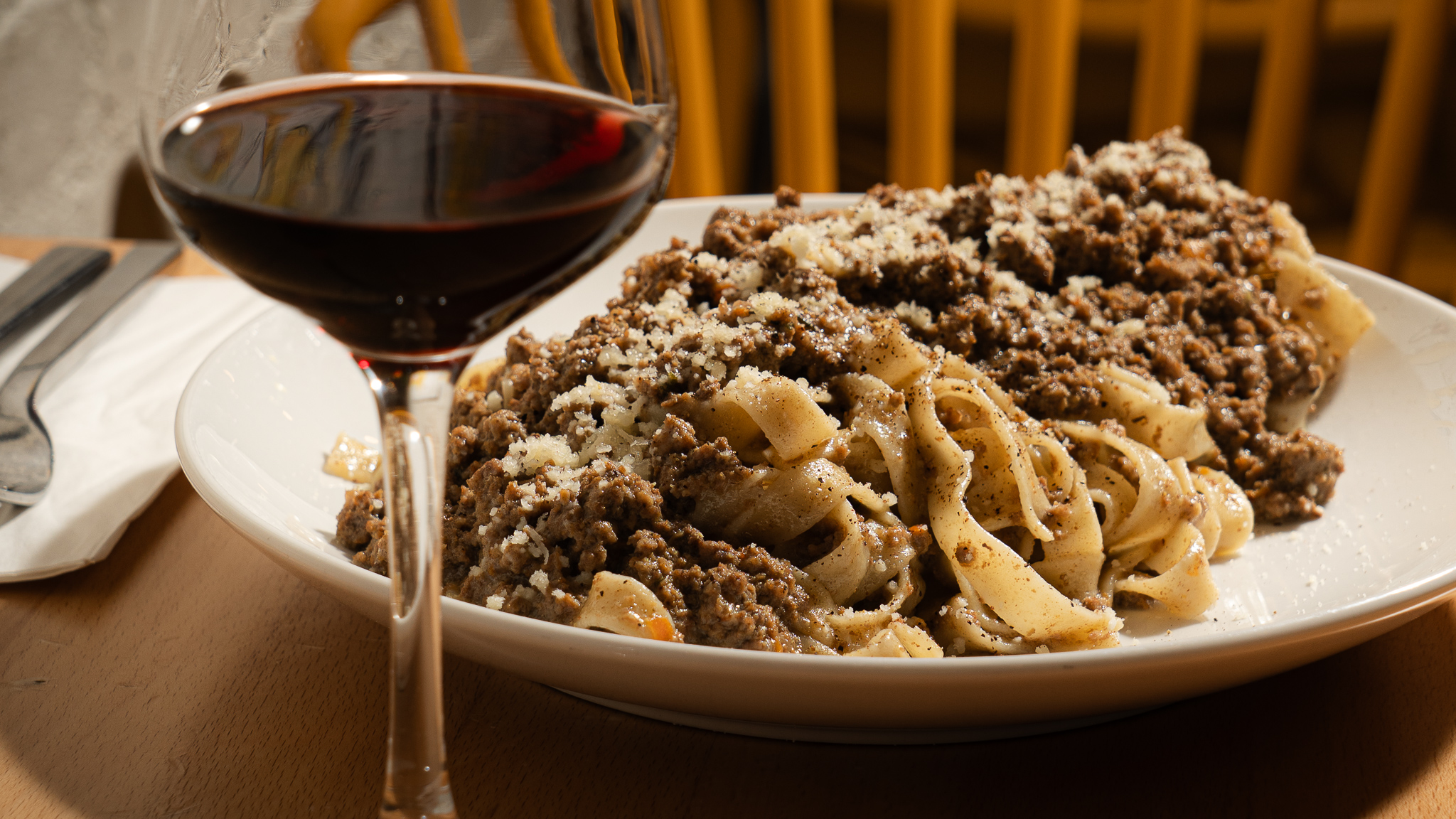 Fresh egg tagliatelle and red wine glass at Pasta Eater Hell's Kitchen