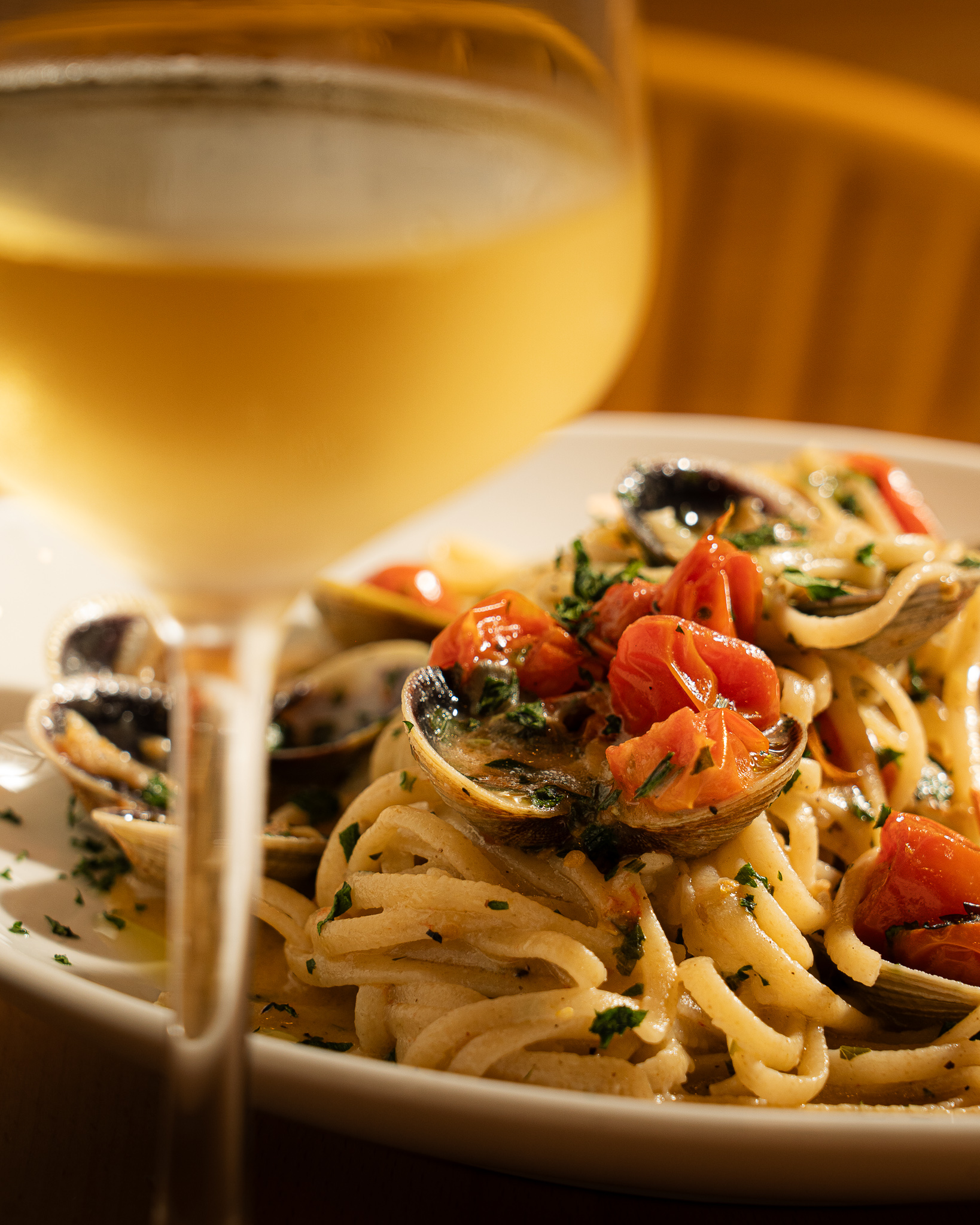 Linguine alle vongole and chilled white wine at Pasta Eater Hell's Kitchen NYC