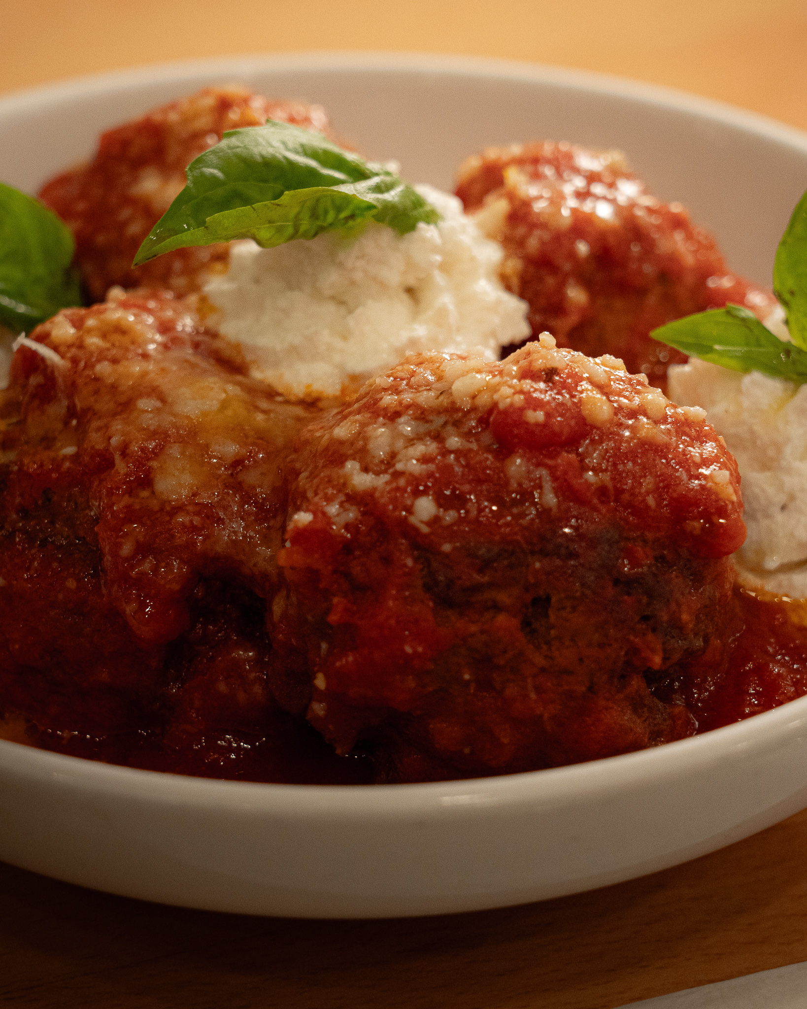 Polpette della nonna with whipped ricotta and fresh basil at 744 9th Ave NYC